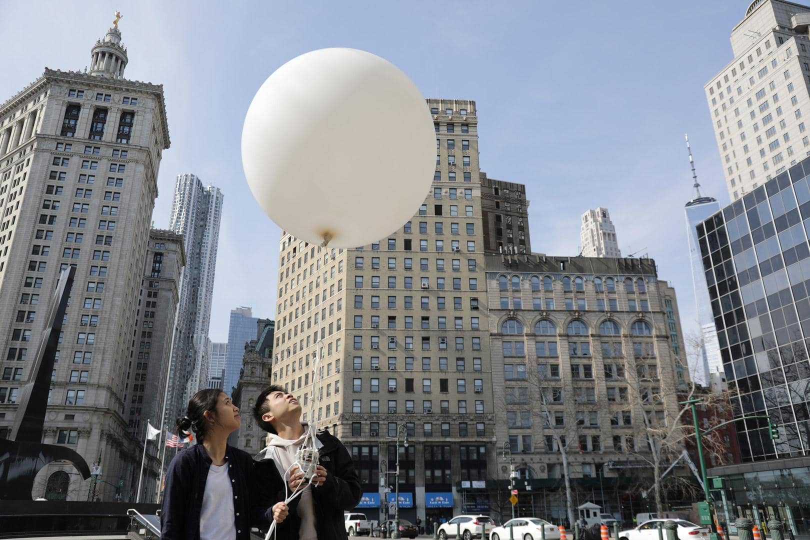 Winnie and Rui holding a weather balloon and the popeye machine