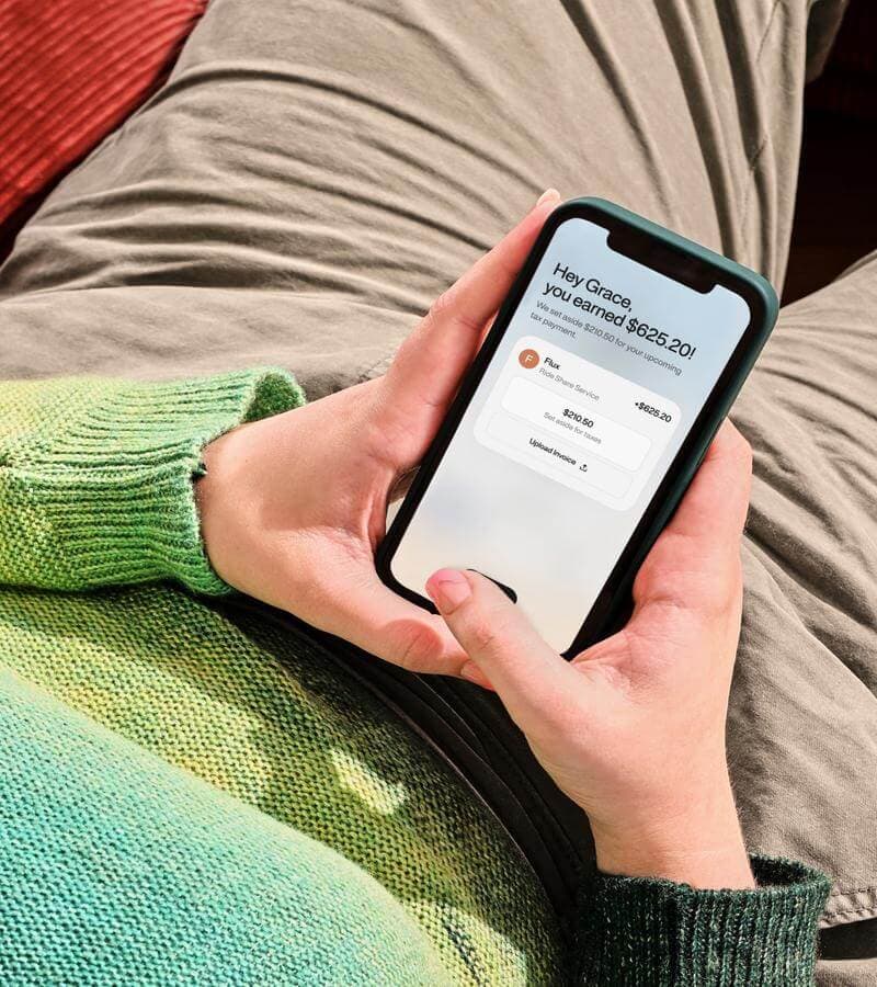 Person holding a phone with income notification from the WorkMade app